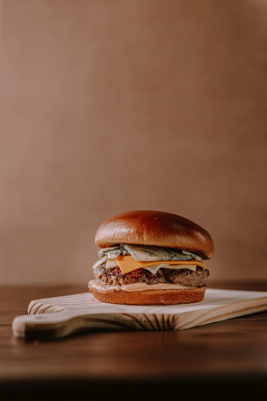 a hamburger sitting on top of a wooden  board