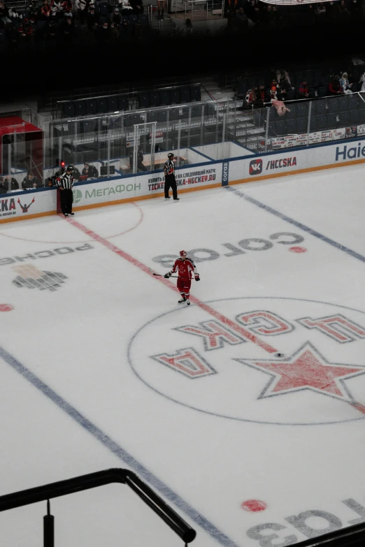 hockey players skating on the ice at an indoor arena