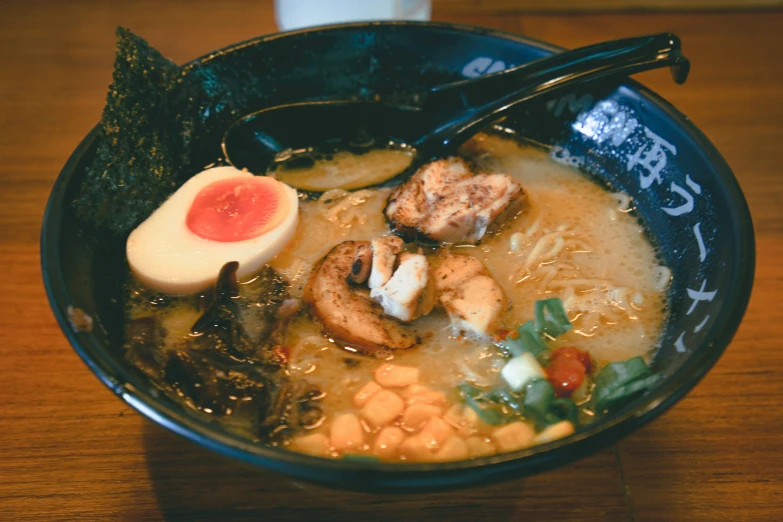 a bowl of soup with meat and vegetables in it