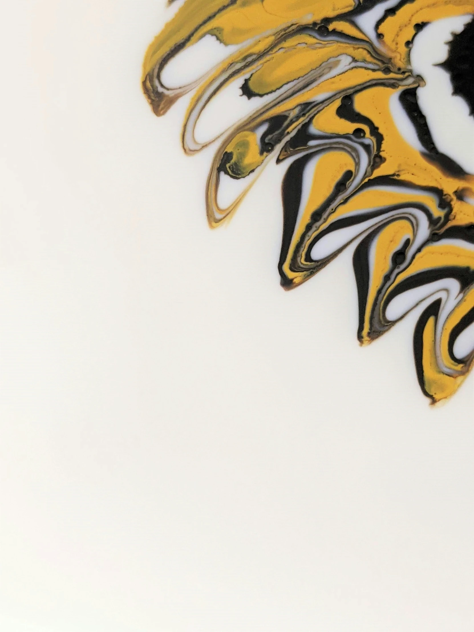 some yellow and black swirls on a white surface