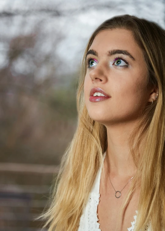 a woman with long hair is looking up at soing