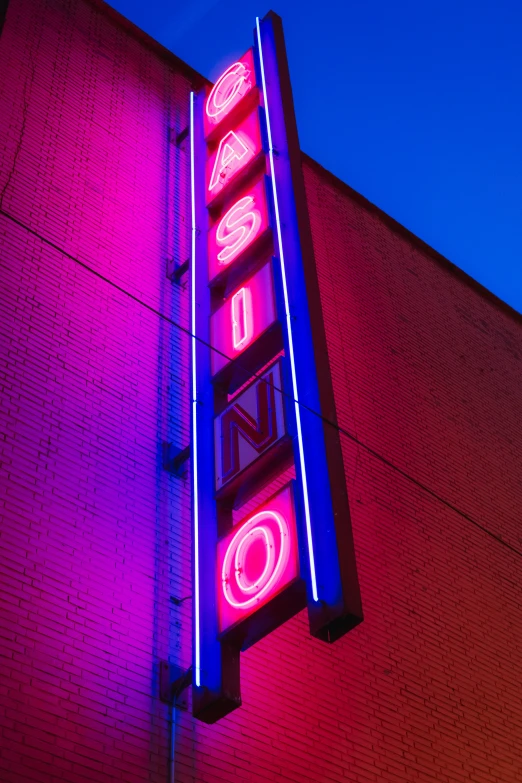 a bright neon sign is displayed on a building