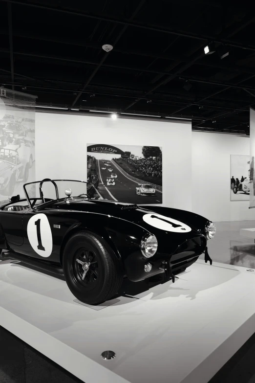 a very classic race car sitting on display in a museum