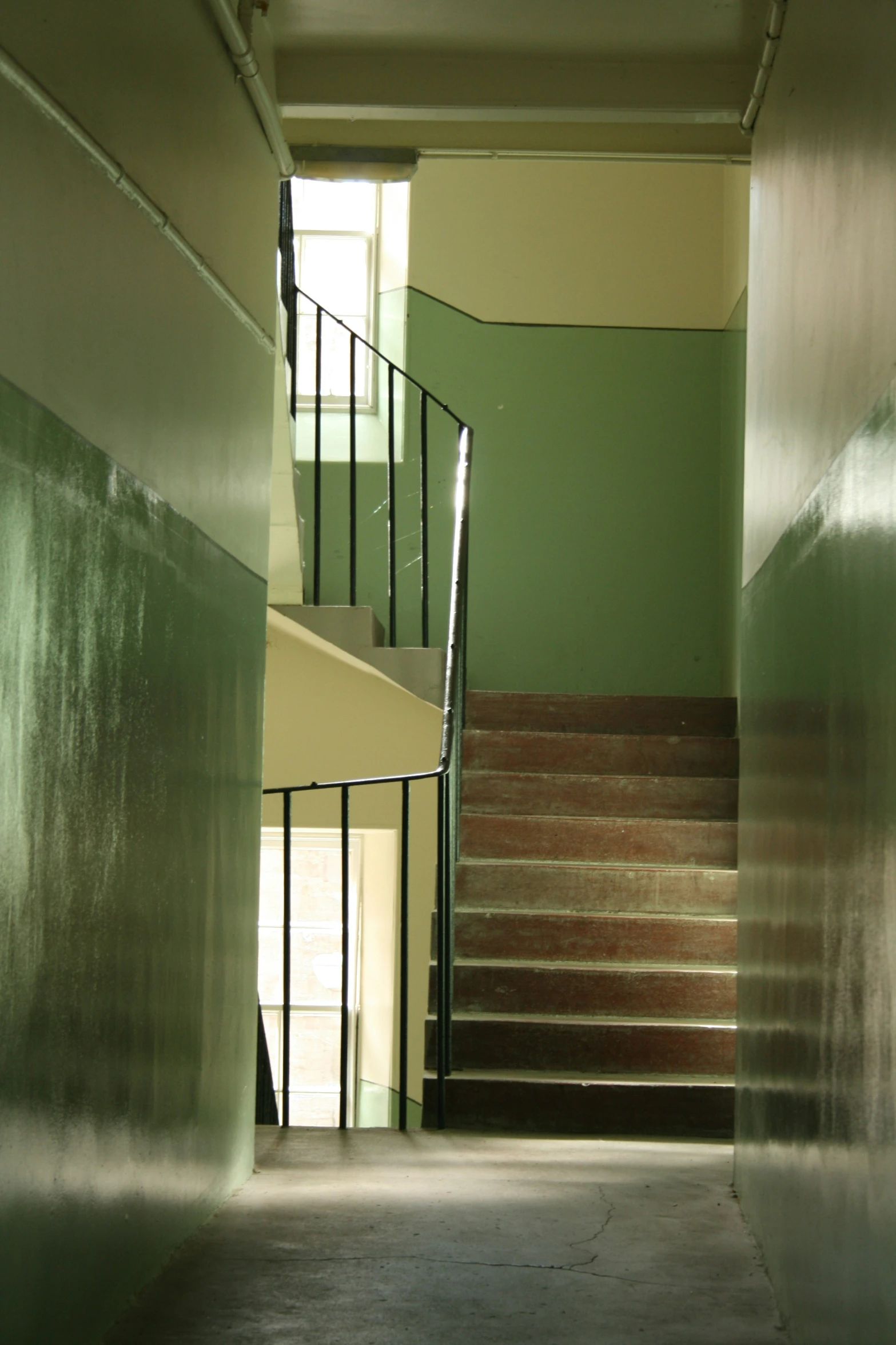 a stairway that is next to some metal railing