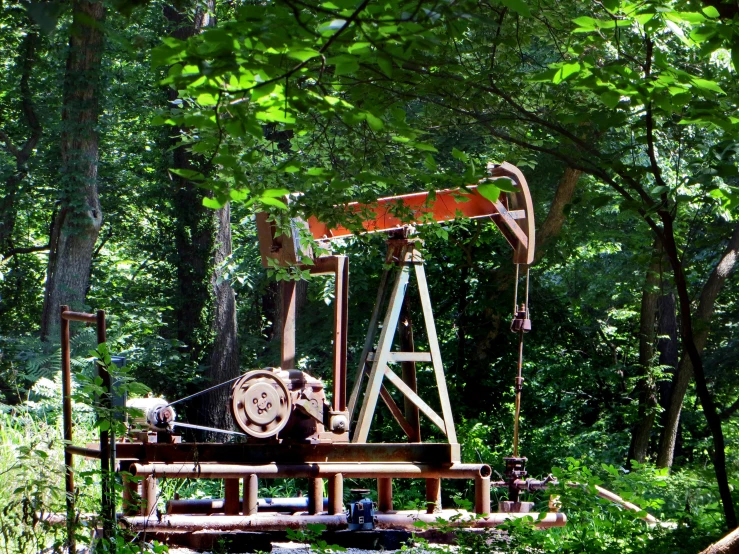 an oil well that is sitting in the middle of some woods