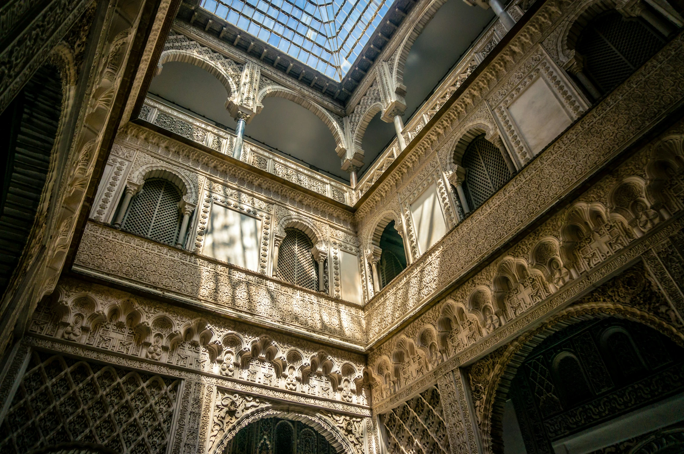 an indoor room with a glass roof and chandelier