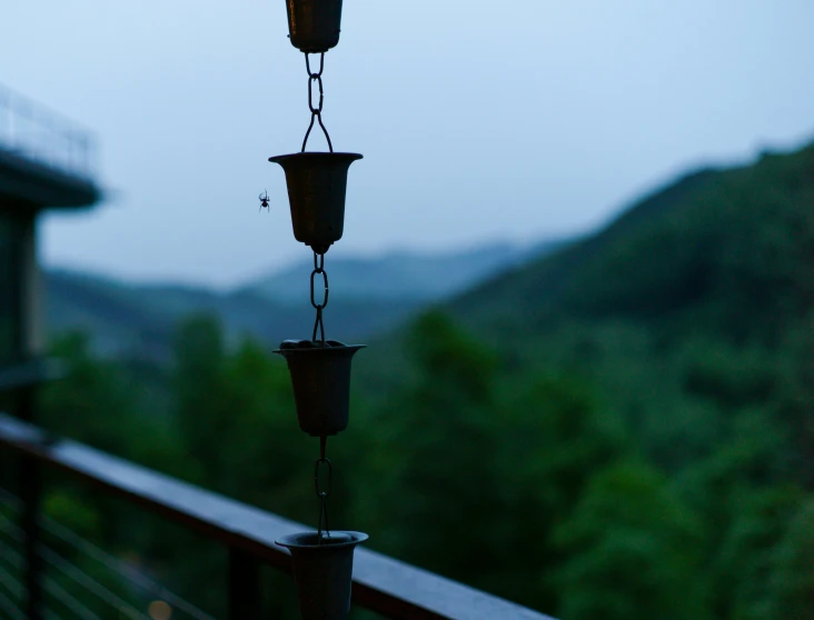 an empty candle is  on the rail of a balcony