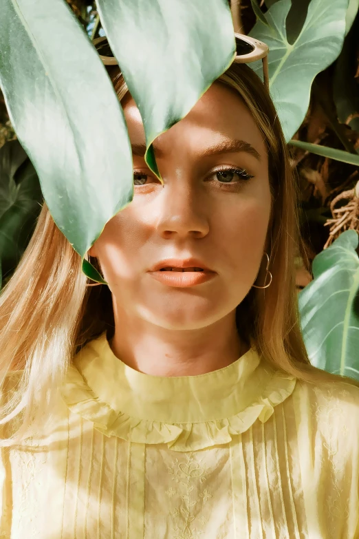 woman with a green leaf on top of her head