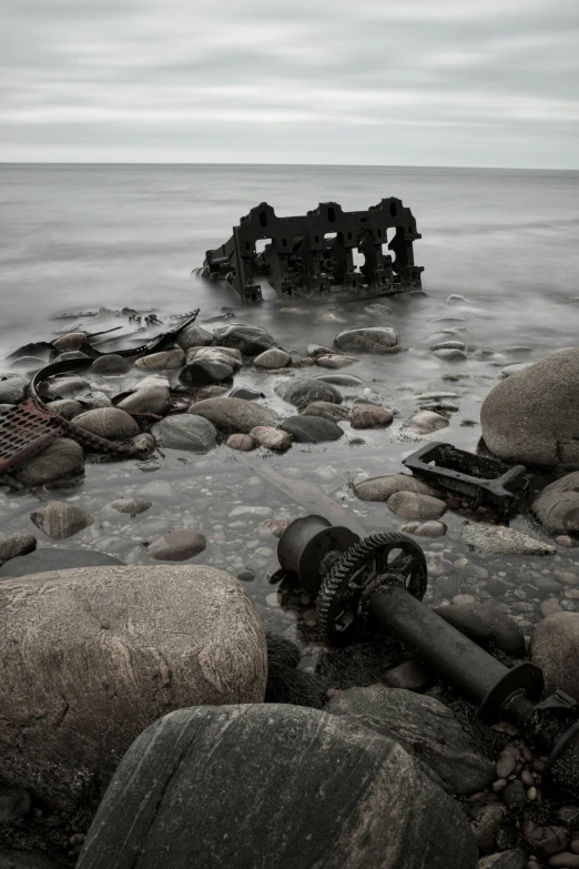 an image of a wreck that is on a rocky beach