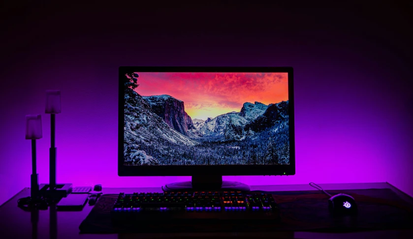 a computer monitor with a mouse and keyboard on top of a desk