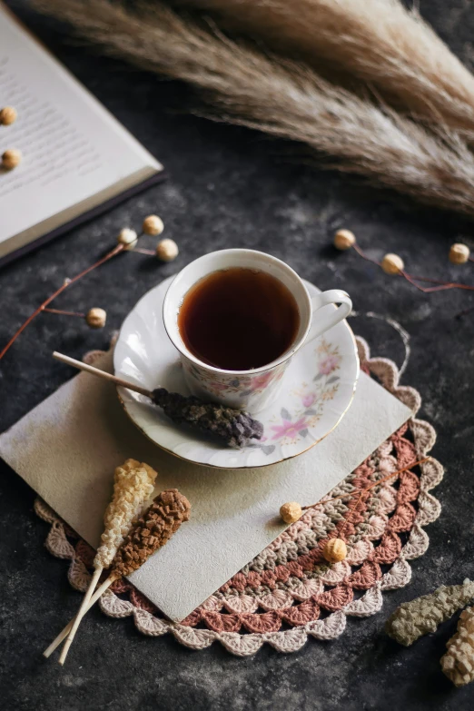 a cup of coffee and some seeds are on a placemat