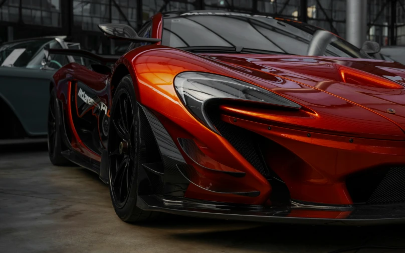 an exotic red sports car parked in a garage