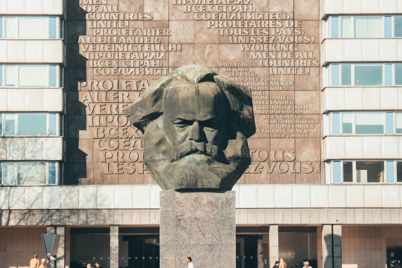 a bust of a man next to a building