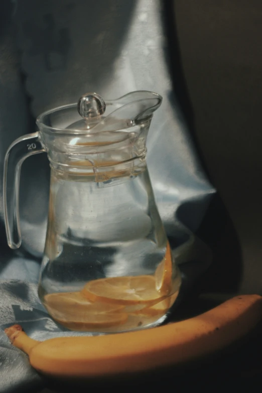 a banana that is sitting next to a jar