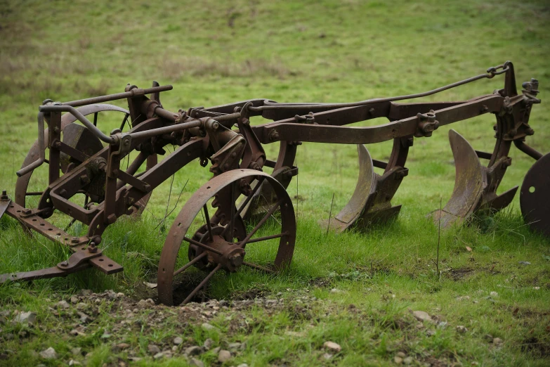 two metal plow wheels attached to one another