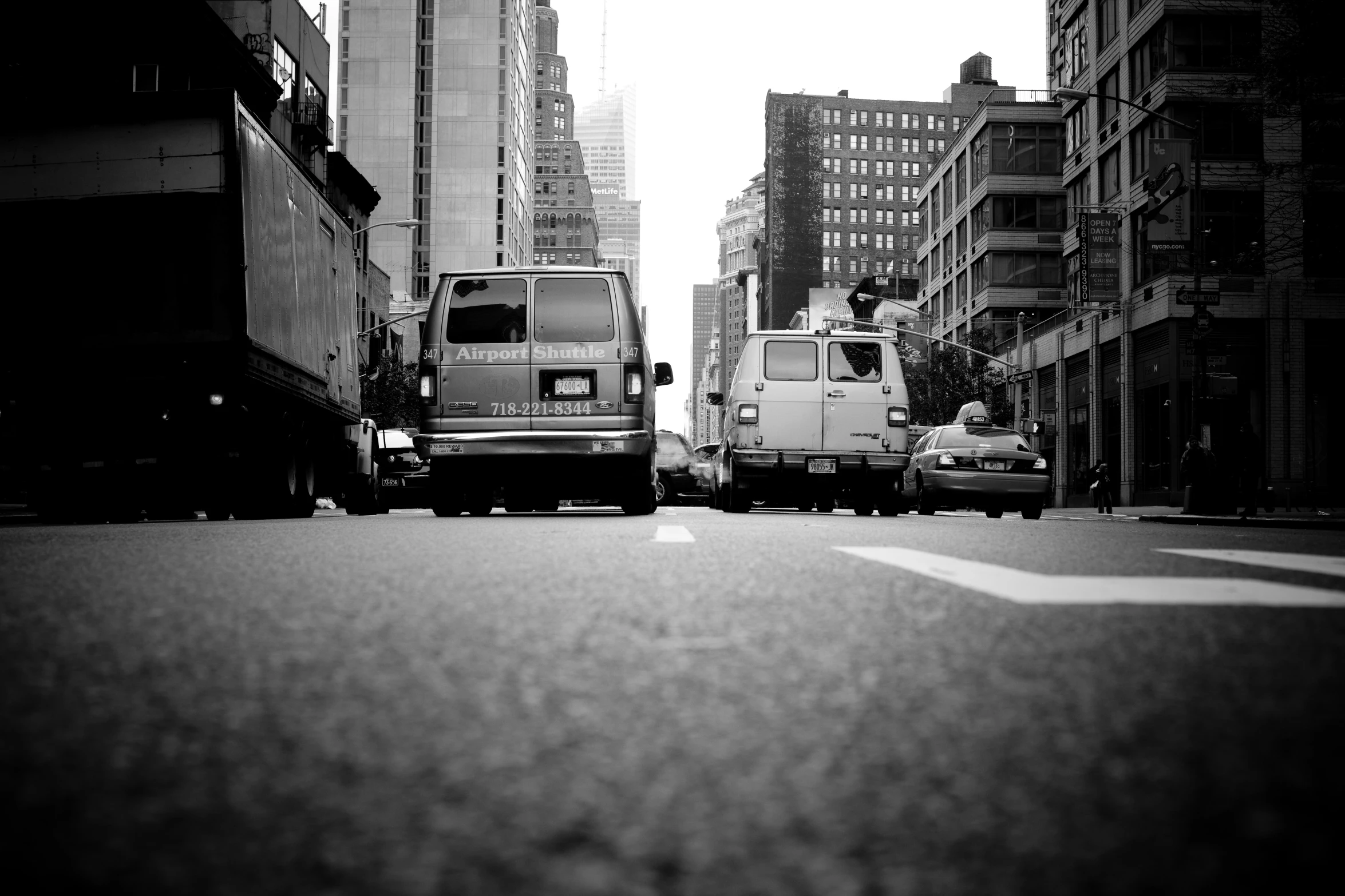 two buses and a van on a city street