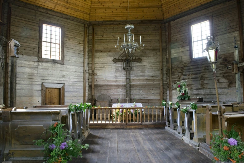 a room with wooden walls and decorated pews