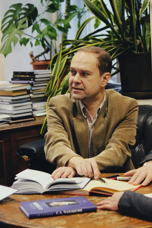 the two men are talking to each other in their office