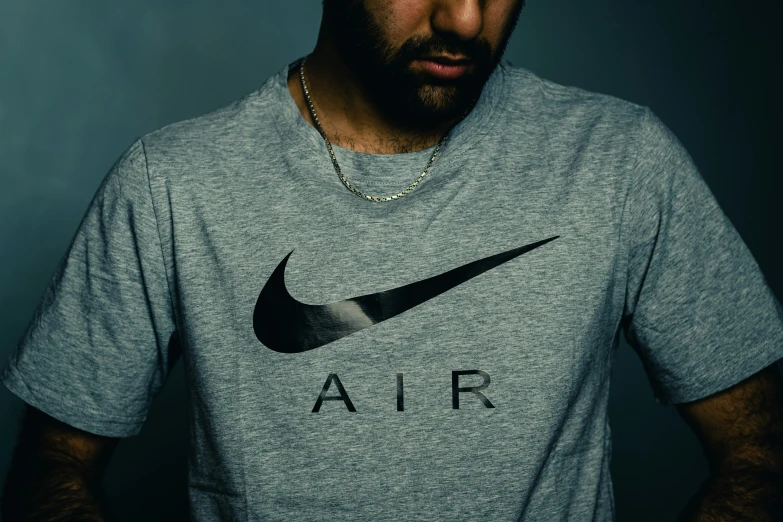 a man wearing a nike air shirt while standing up