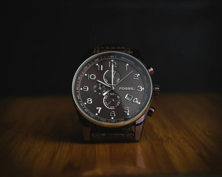 an image of a wristwatch sitting on a wooden surface