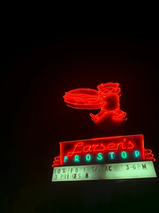 the famous poseps post store sign lit up at night