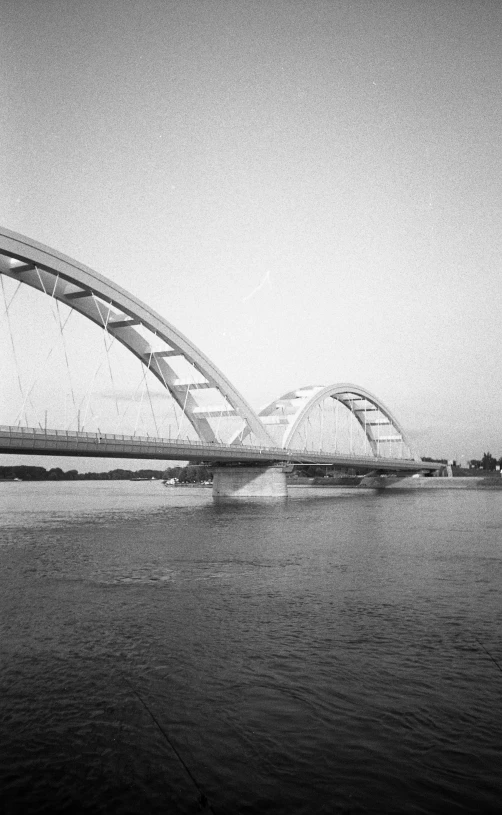 the black and white po shows a large bridge spanning a wide river