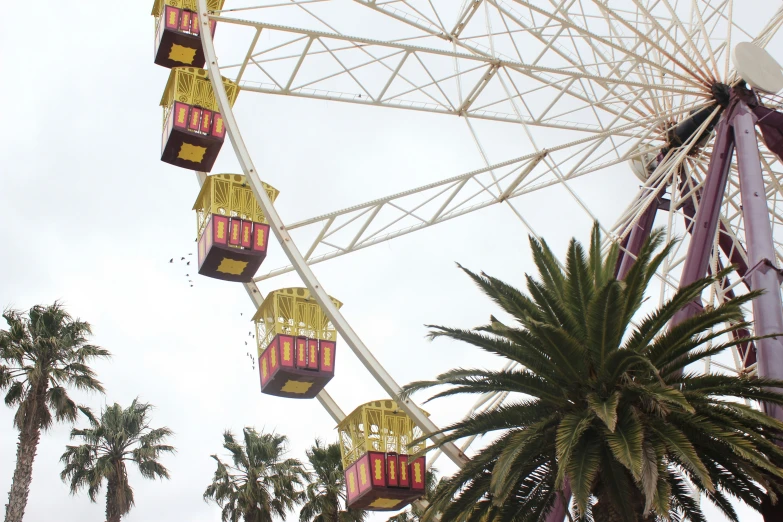 an ferris wheel with three hanging baskets above