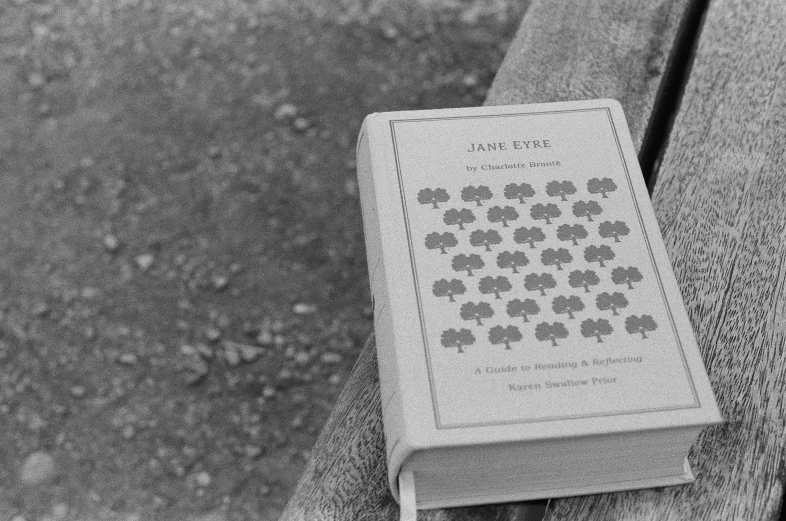 a closeup of the back of a book resting on a bench