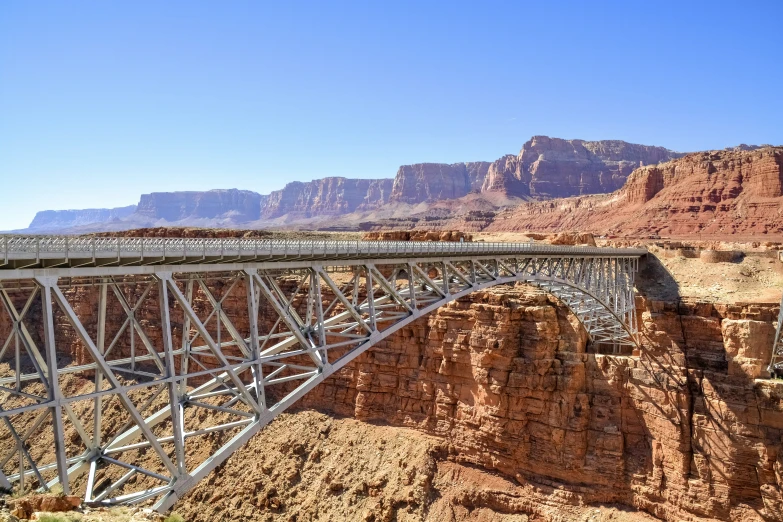 a large metal bridge spanning over a canyon