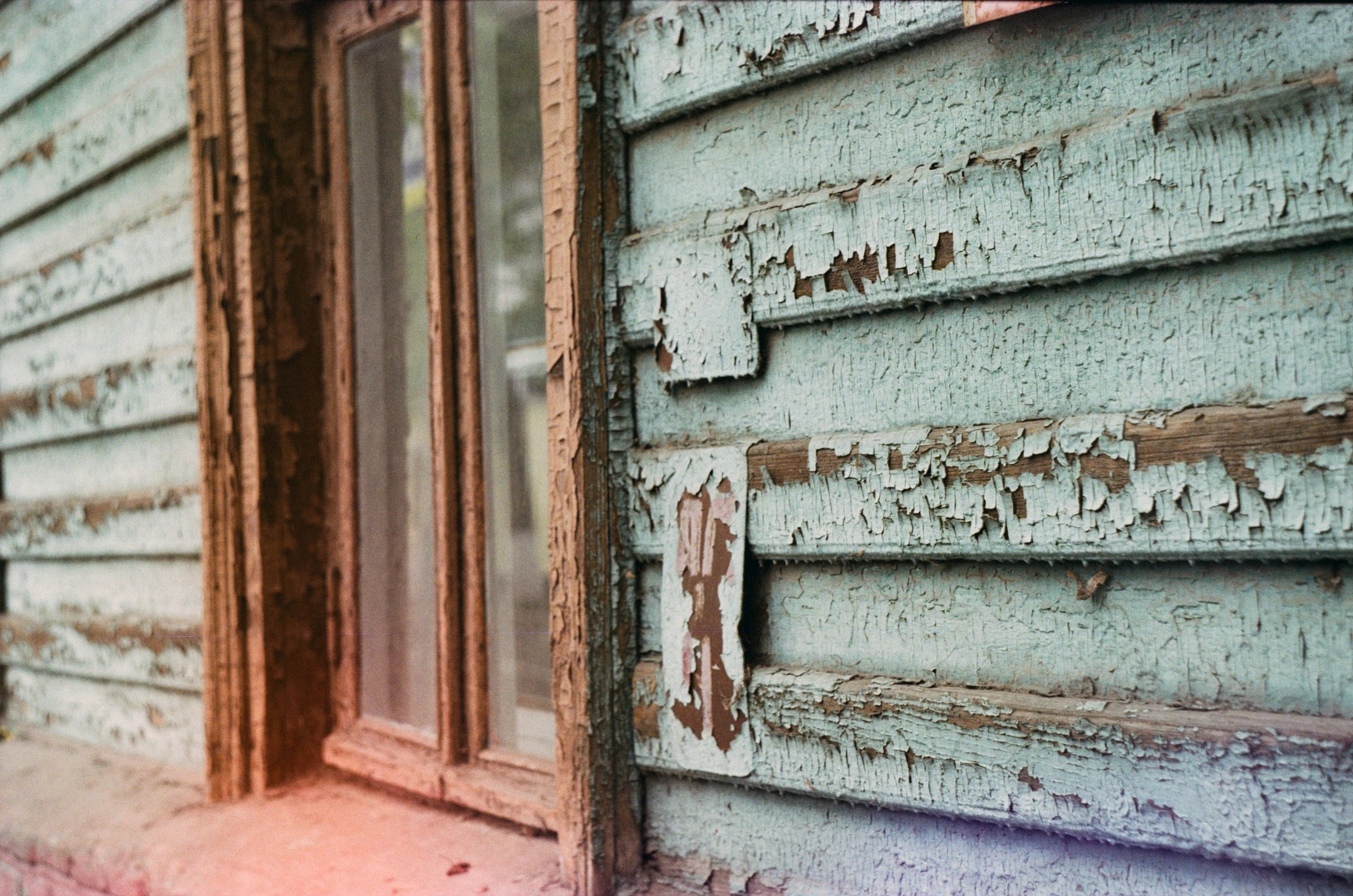 a boarded up window of a house that is not finished