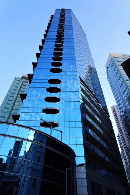 an office building reflecting the blue sky