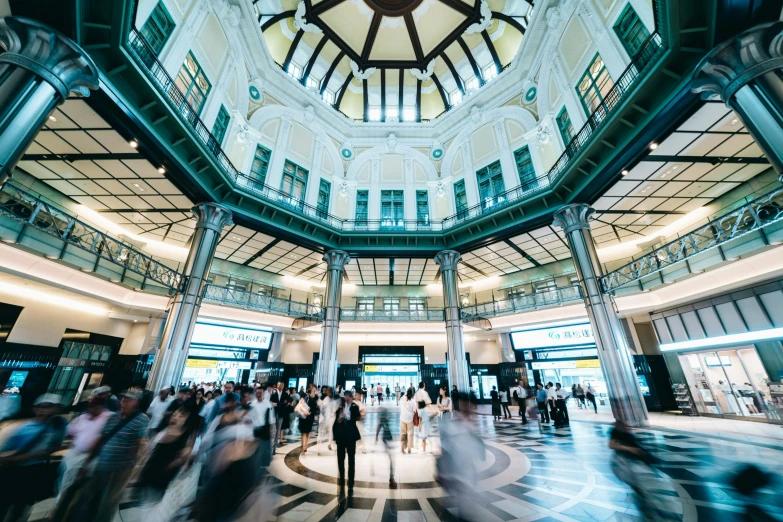 a large group of people are walking through the building