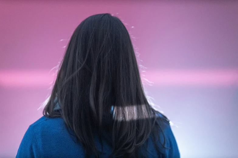 woman with long hair facing away from camera