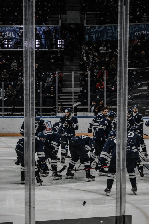 an image of a hockey game between the opposing teams