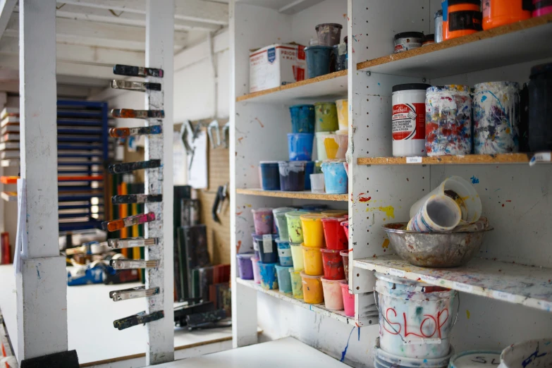 an image of a bunch of shelves full of painting supplies