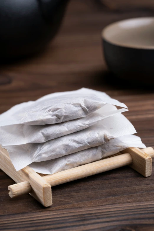 a stack of tea bags on a small wooden stand