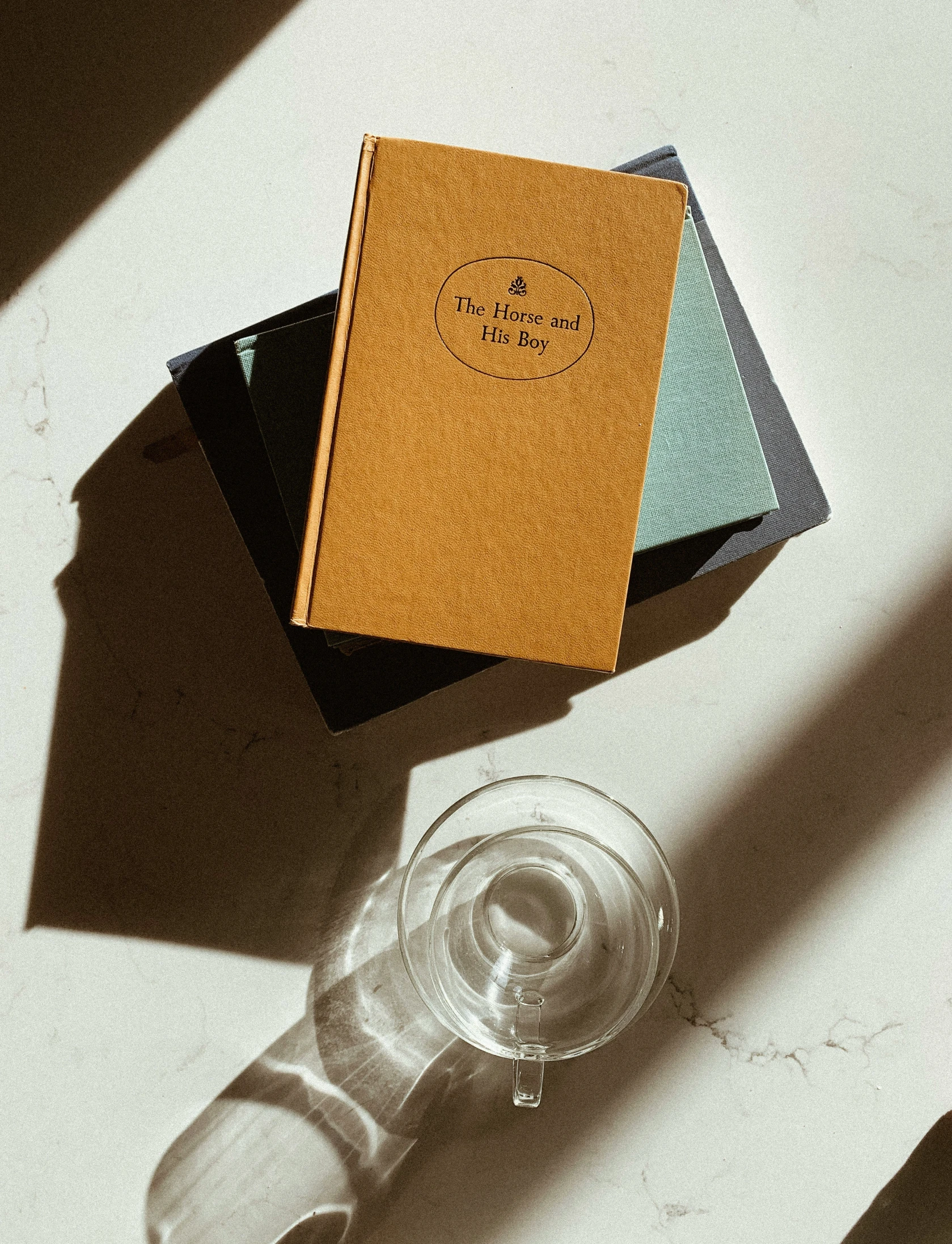 a wine glass and a book are on a table