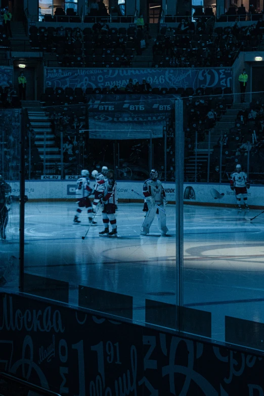 the ice hockey teams are playing a game in front of a crowd