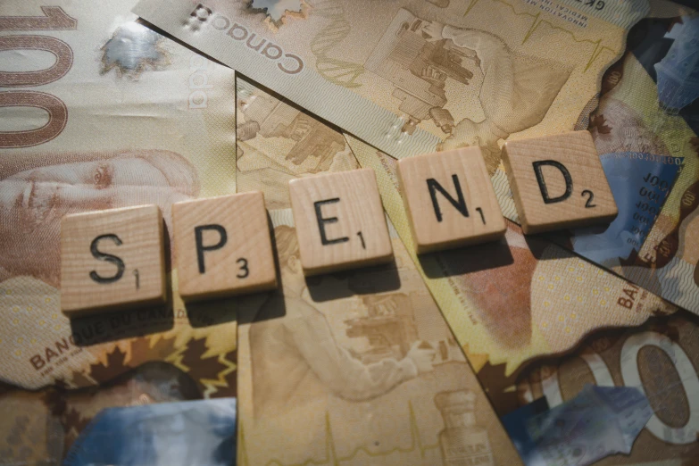 scrabble letters that spell spend in wood blocks