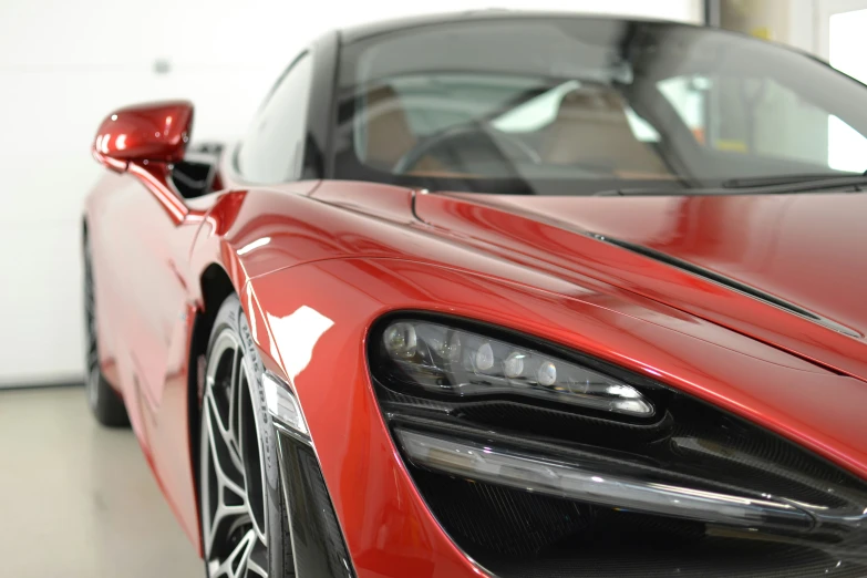 the front of a red sports car with the hood open