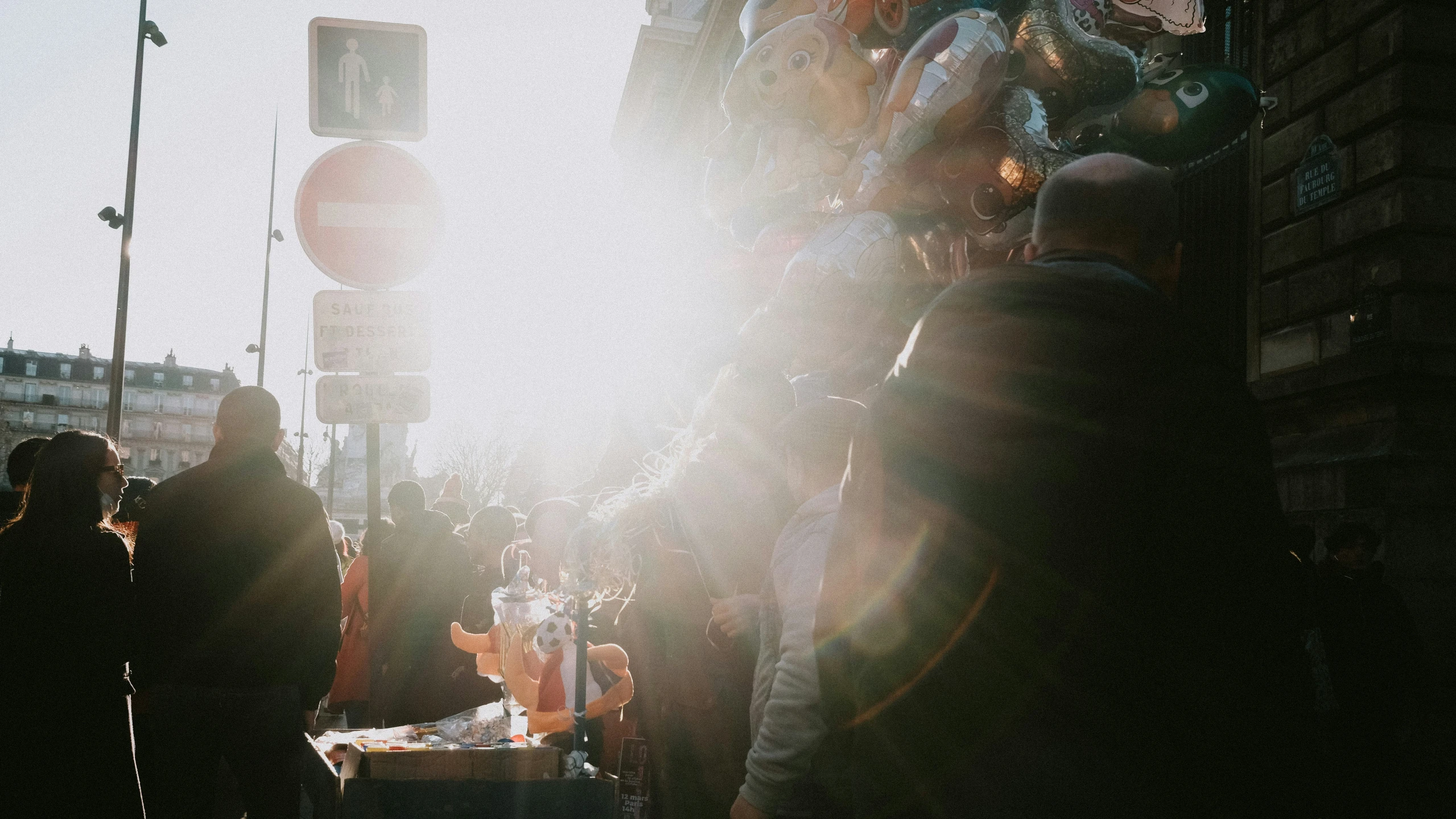 people in a crowded street area near a traffic light