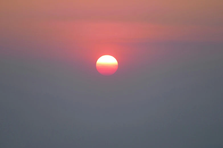 a boat on the sea at sunset, near shore