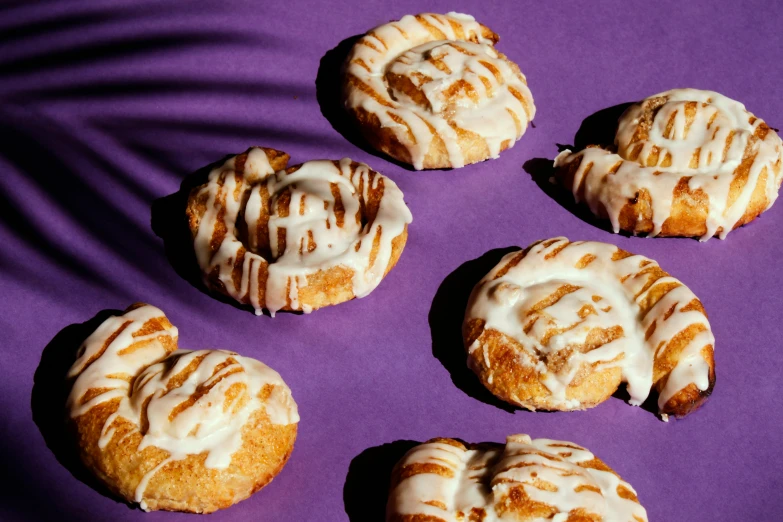 seven baked goods arranged in a grid on a purple background