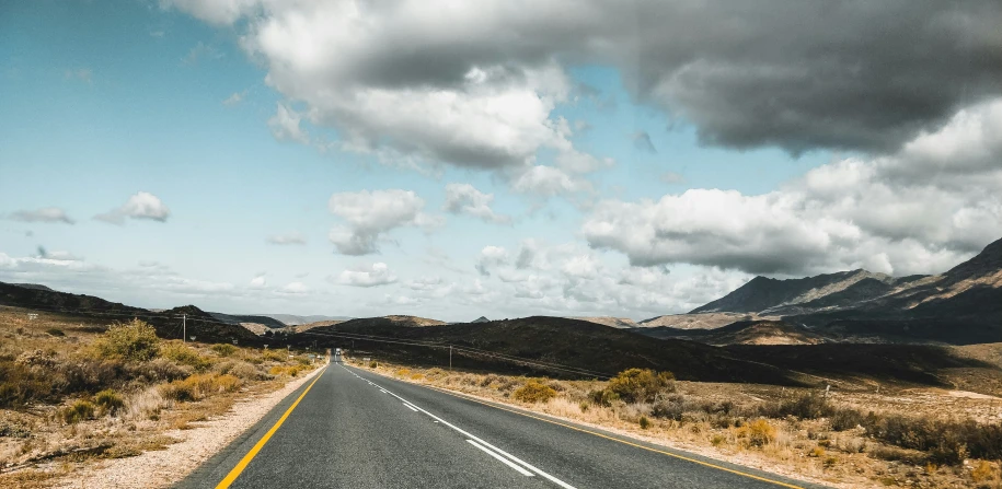 a deserted road sits empty in the middle of the desert