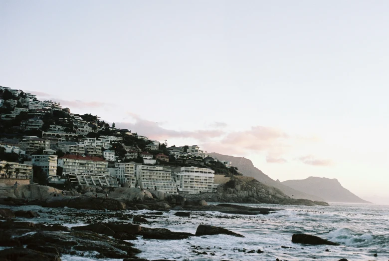 a city with rocky shorelines and waves coming in