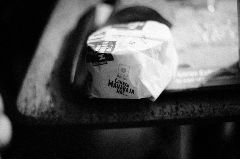 black and white pograph of wrapped food on wooden table