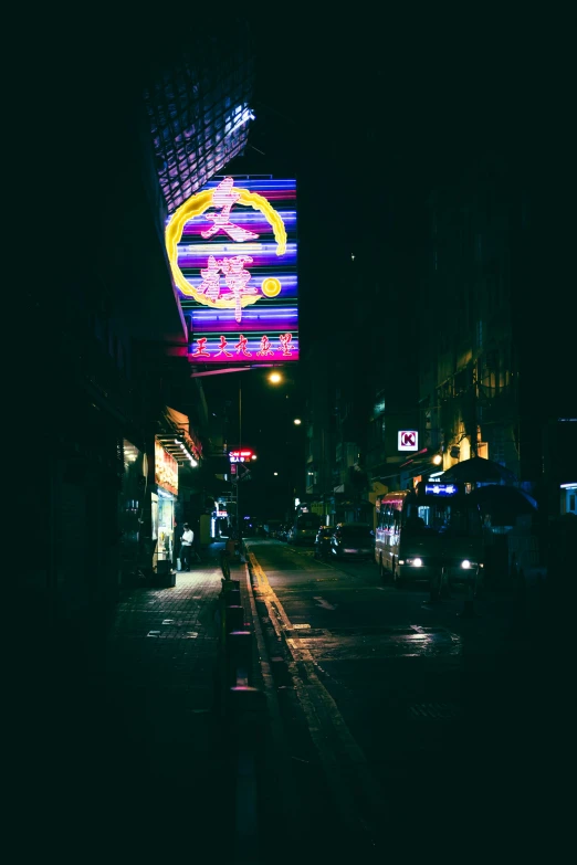 night time street scene showing neon sign on building