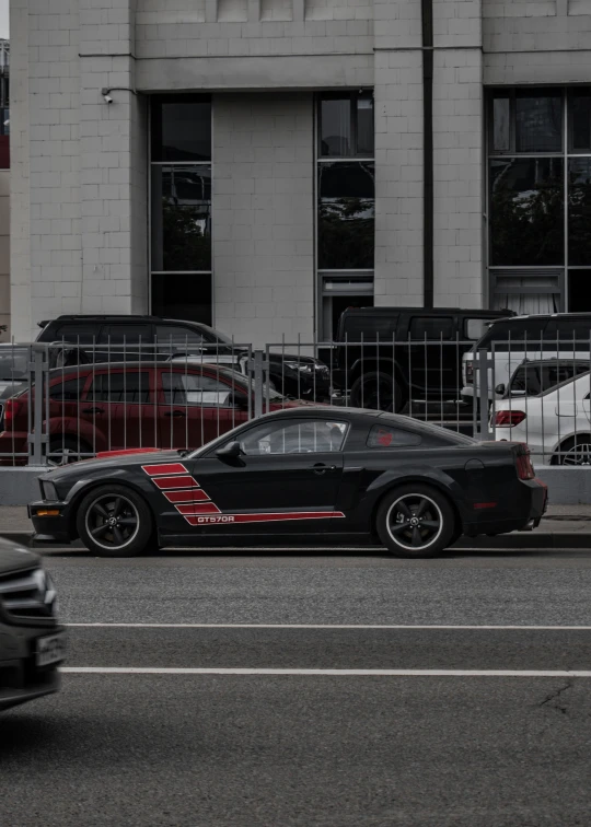 there is a small black car parked on the street