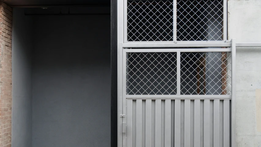 a gated entrance to a door with a window in it