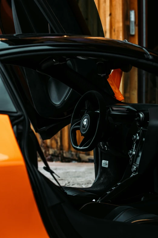 the inside of an orange sports car door